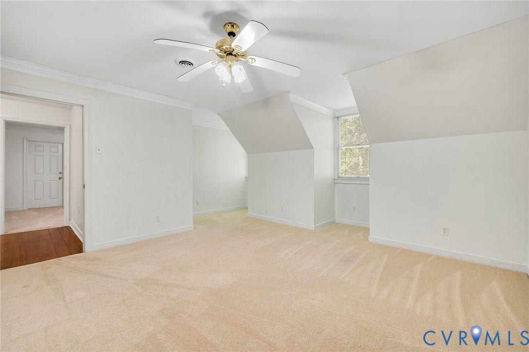 2409 Three Bridge Road, Rural, Powhatan, VA 23139 Expansive room featuring neutral-toned carpeting, a ceiling fan, and sloped ceiling details