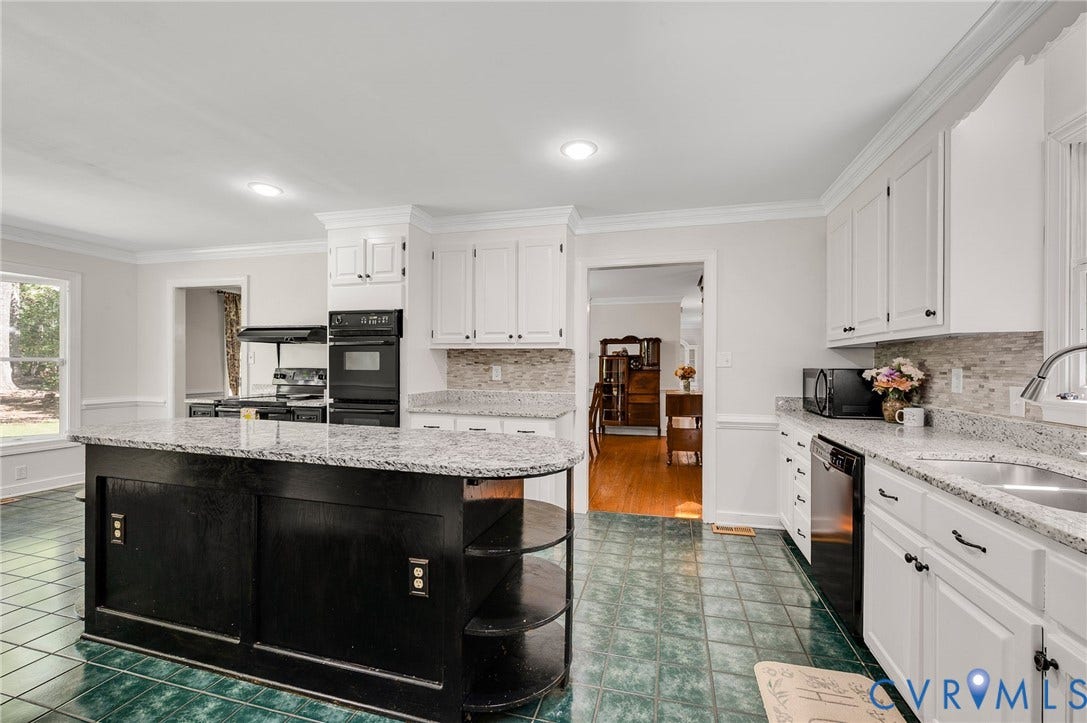 2409 Three Bridge Road, Rural, Powhatan, VA 23139 Kitchen featuring white cabinetry, a black island with shelving, granite countertops, a built-in double oven, and a tiled backsplash