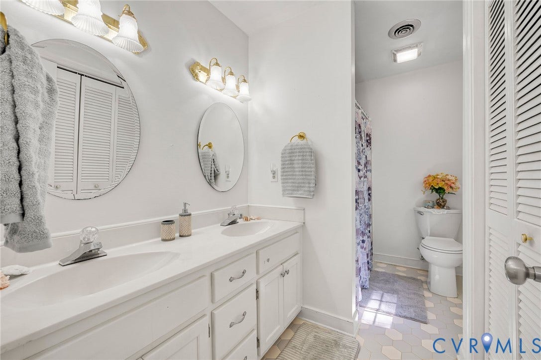 2409 Three Bridge Road, Rural, Powhatan, VA 23139 Dual vanity with integrated sinks, white cabinetry, and brushed nickel hardware