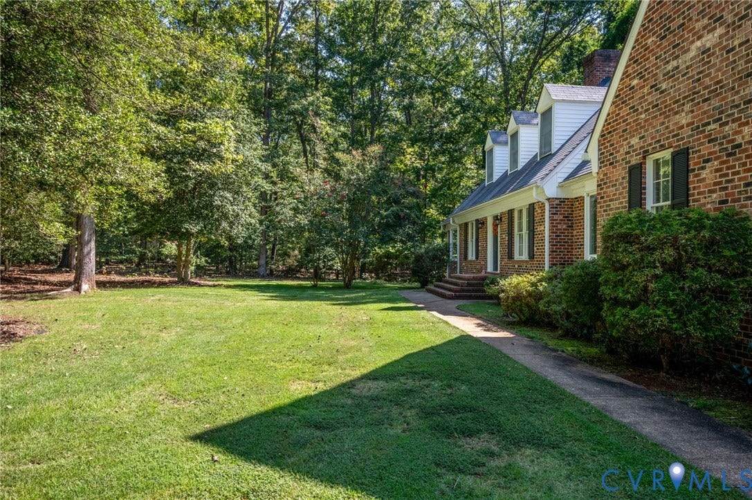2409 Three Bridge Road, Rural, Powhatan, VA 23139 Brick exterior with dormer windows, covered front entry, established landscaping, and a substantial lawn area