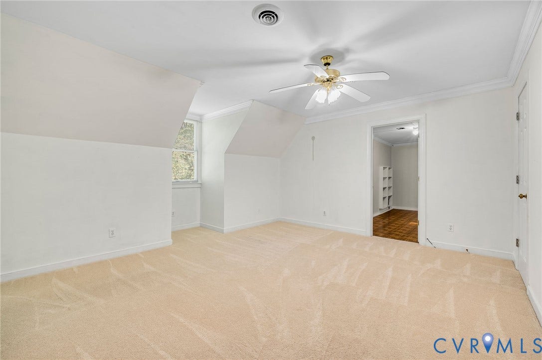 2409 Three Bridge Road, Rural, Powhatan, VA 23139 Carpeted room with a ceiling fan, crown molding, a window, and an adjoining space featuring wood-finish flooring and built-in shelving