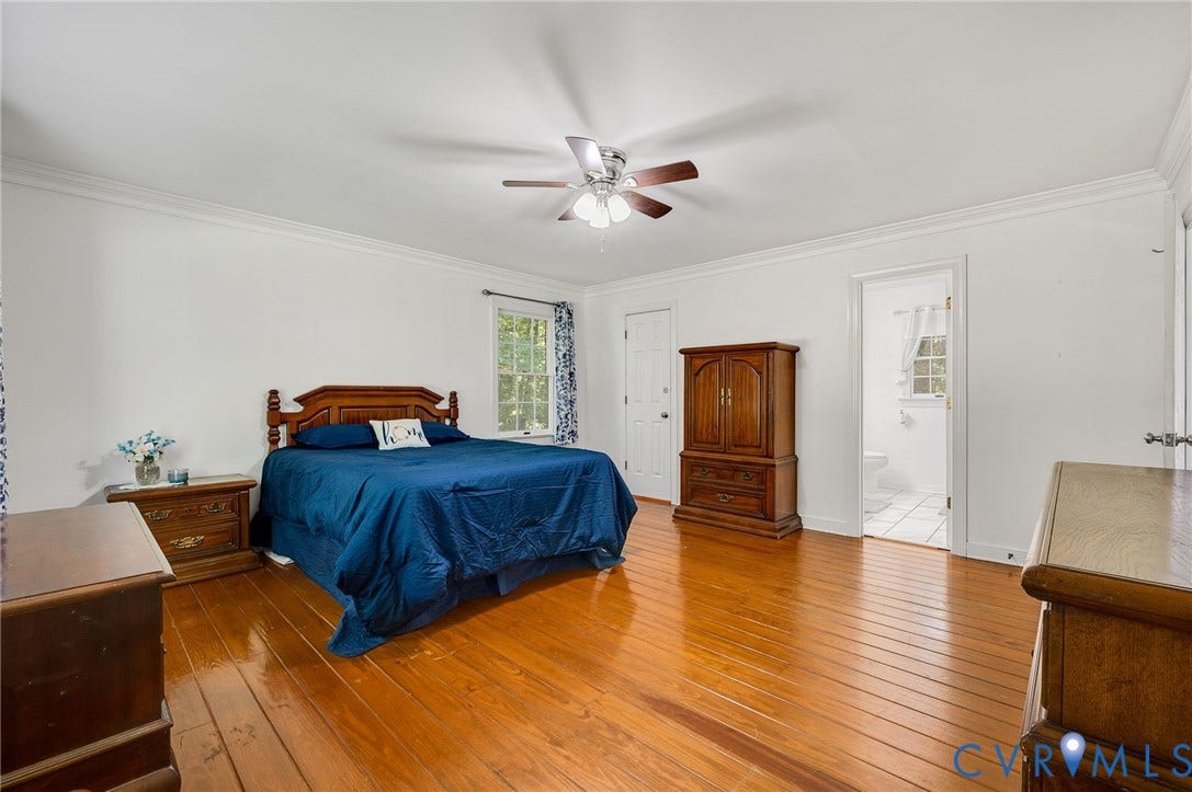 2409 Three Bridge Road, Rural, Powhatan, VA 23139 Hardwood flooring, ceiling fan with light fixture, painted white walls, white trim, and a window for natural light