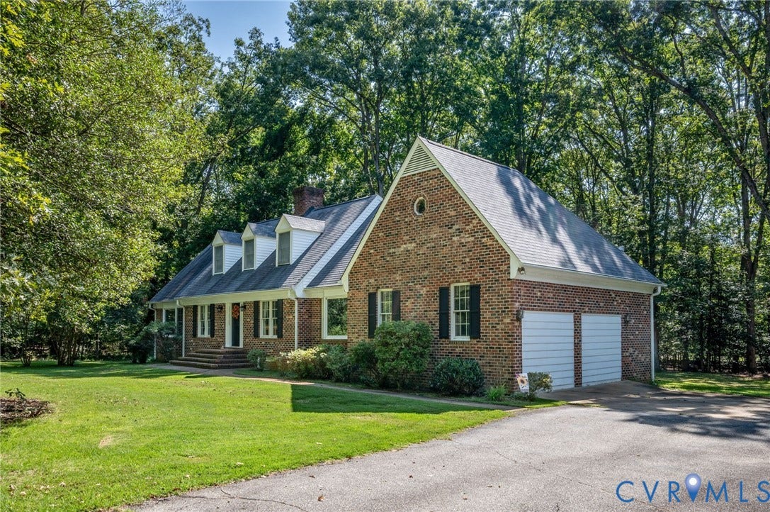 2409 Three Bridge Road, Rural, Powhatan, VA 23139 Brick exterior featuring a gabled roofline, multiple dormer windows, and a two-car garage