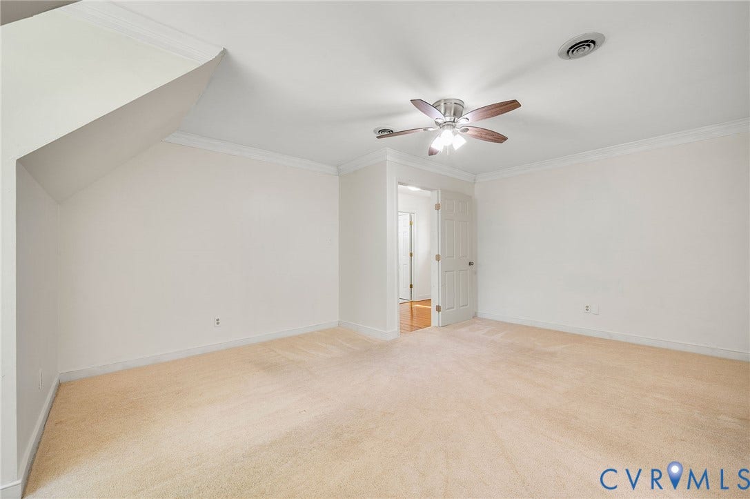 2409 Three Bridge Road, Rural, Powhatan, VA 23139 Wall-to-wall carpeting, ceiling fan with light fixture, crown molding, and a white paneled door