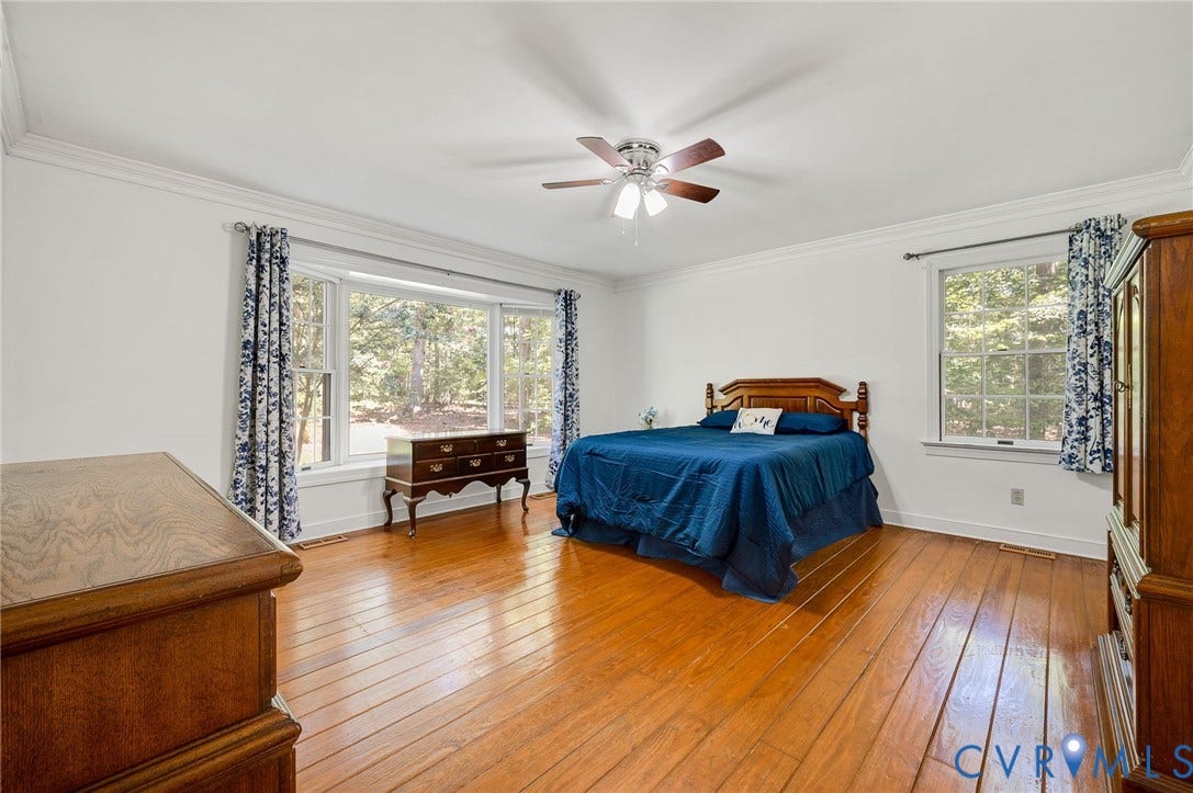 2409 Three Bridge Road, Rural, Powhatan, VA 23139 Hardwood flooring, white walls, crown molding, ceiling fan, and multiple windows