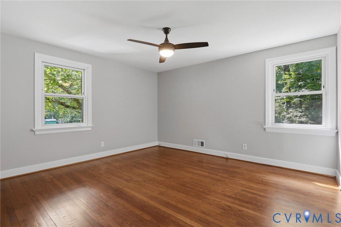 8349 Charlise Road, Oxford, Richmond, VA 23235 Hardwood flooring, painted walls, ceiling fan with integrated lighting, and two windows with white trim