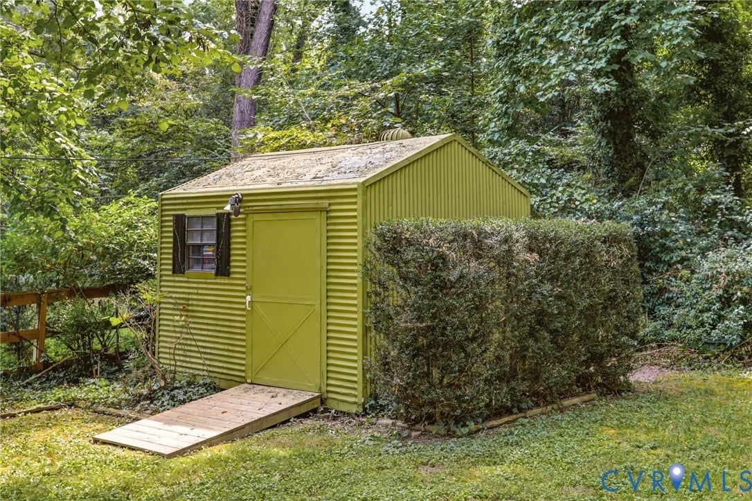 8349 Charlise Road, Oxford, Richmond, VA 23235 Corrugated metal storage shed with a single window, exterior lighting fixture, and an entry ramp