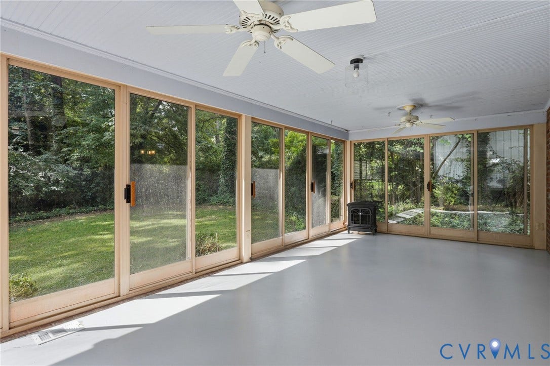 8349 Charlise Road, Oxford, Richmond, VA 23235 Enclosed sunroom featuring multiple ceiling fans, wood-frame glass panel doors, and painted concrete flooring