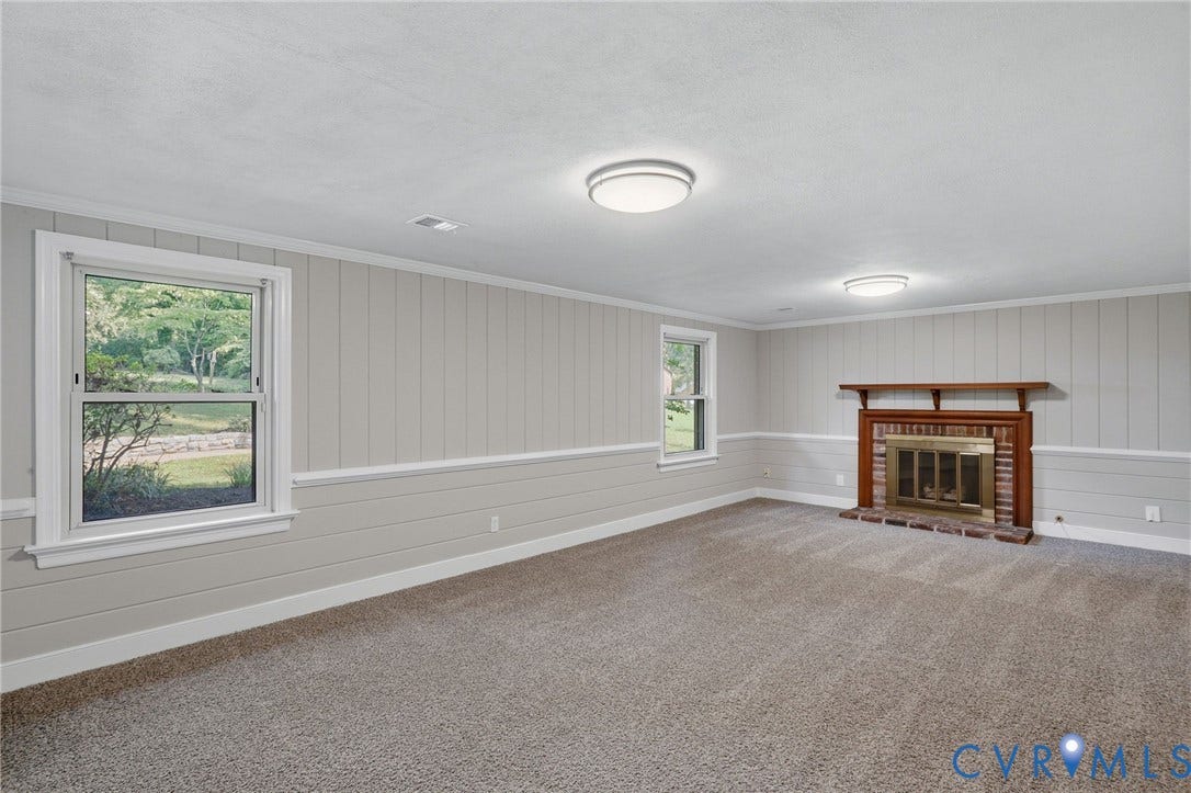 8349 Charlise Road, Oxford, Richmond, VA 23235 Brick fireplace with wood mantel, wall paneling, and neutral carpet flooring