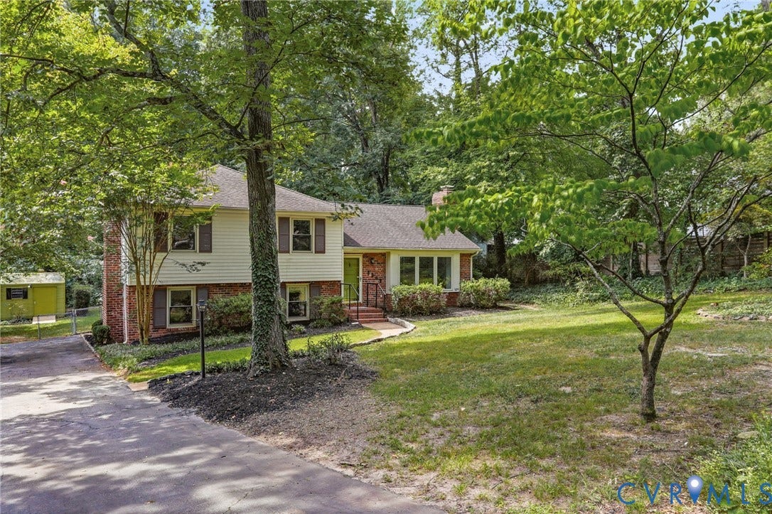 8349 Charlise Road, Oxford, Richmond, VA 23235 Two-story residence featuring a brick and siding exterior, established landscaping, and mature trees