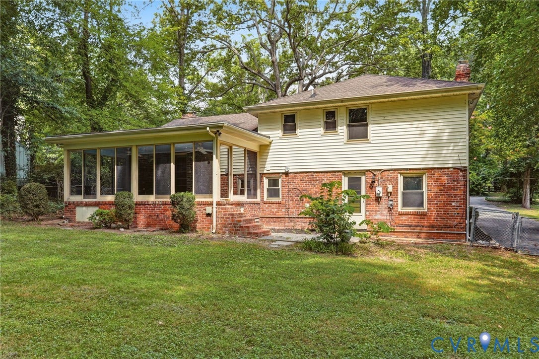 8349 Charlise Road, Oxford, Richmond, VA 23235 Brick and siding exterior featuring an enclosed sunroom and stone patio