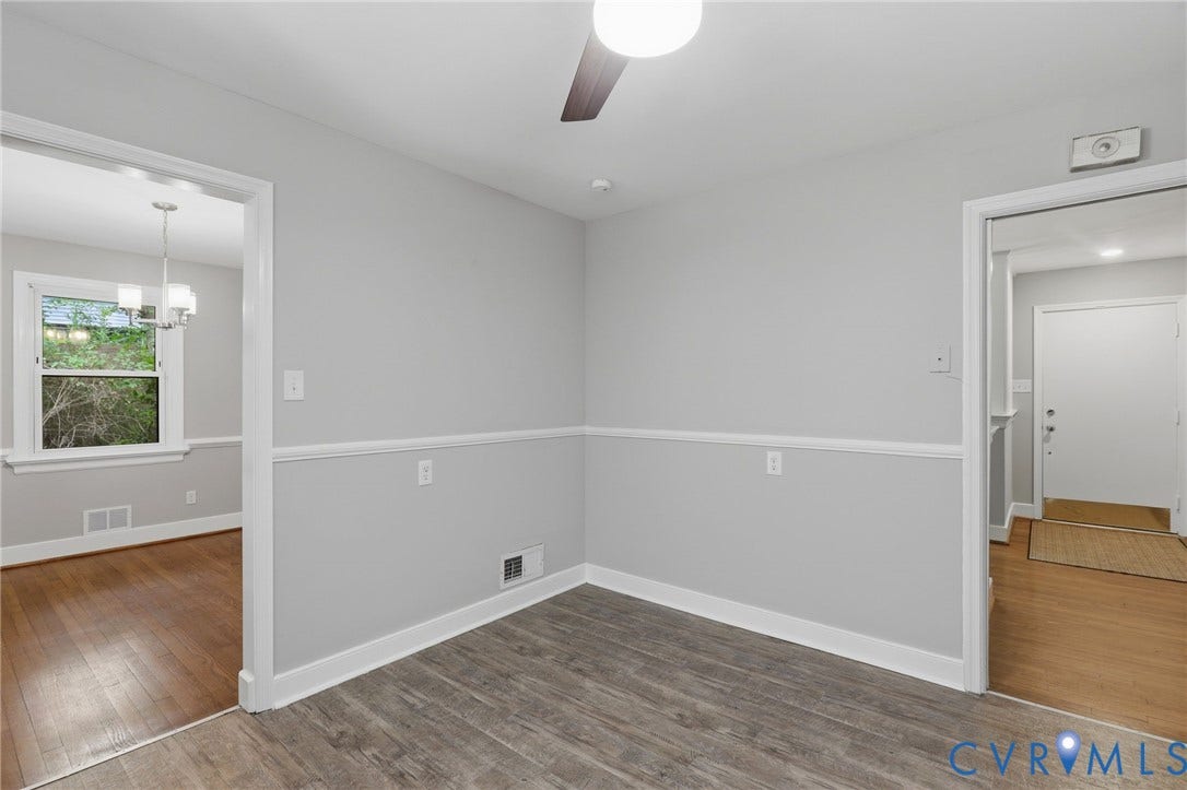 8349 Charlise Road, Oxford, Richmond, VA 23235 Light gray walls with white chair rail molding, wood-finish flooring, and a ceiling fan with integrated lighting