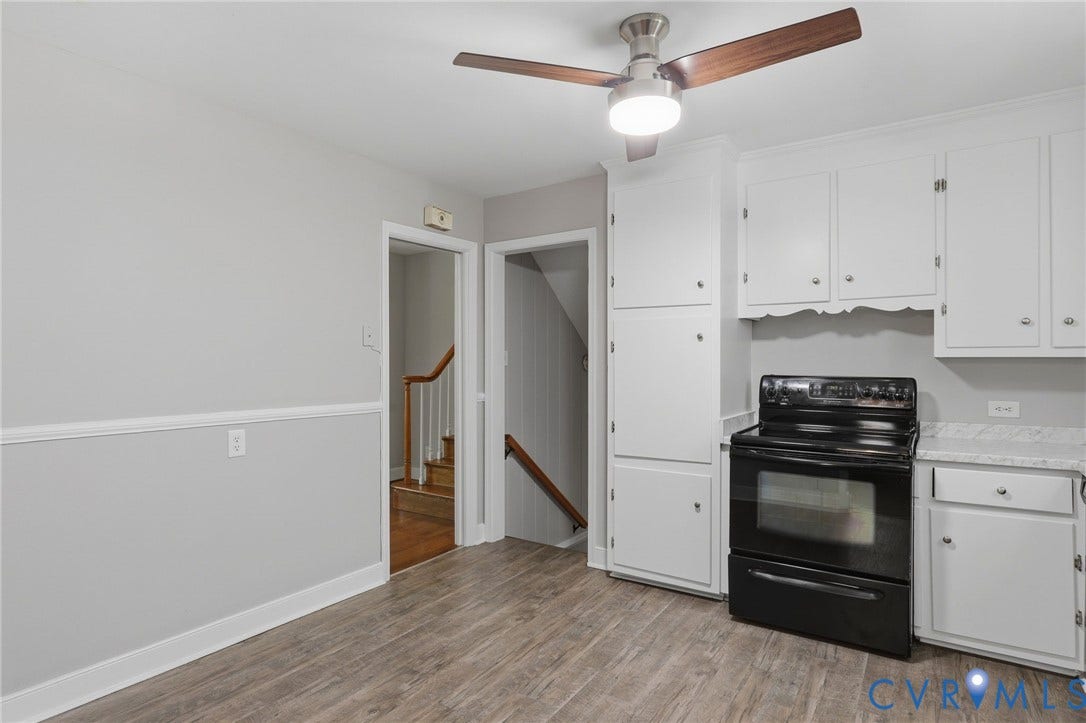 8349 Charlise Road, Oxford, Richmond, VA 23235 Wood-finish flooring, white cabinetry, black range, and ceiling fan with integrated lighting