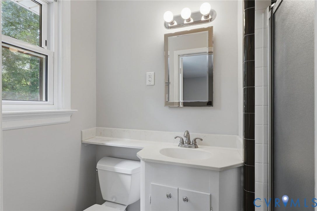 8349 Charlise Road, Oxford, Richmond, VA 23235 White vanity with an integrated sink and chrome faucet