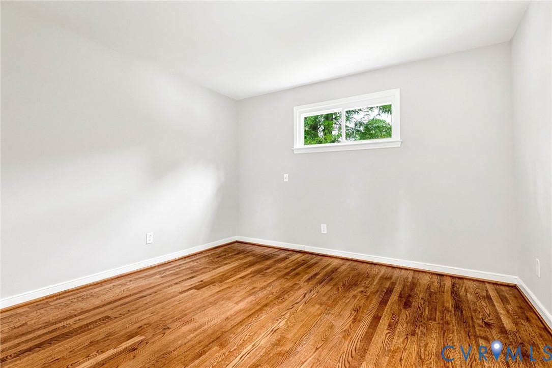 1605 CLOISTER Drive, Henrico, VA 23228 Wood-finish flooring with a white trim, complemented by light-toned wall paint
