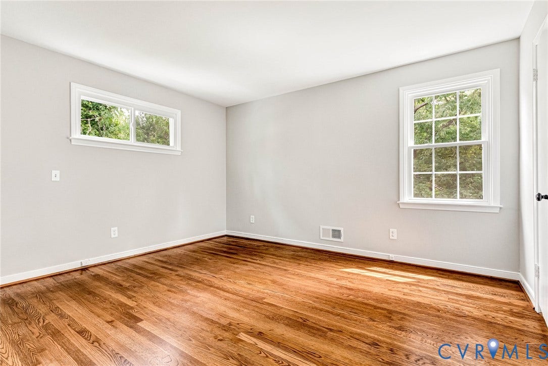 1605 CLOISTER Drive, Henrico, VA 23228 Hardwood flooring, white trim, multiple windows, light-colored walls, and a solid core door