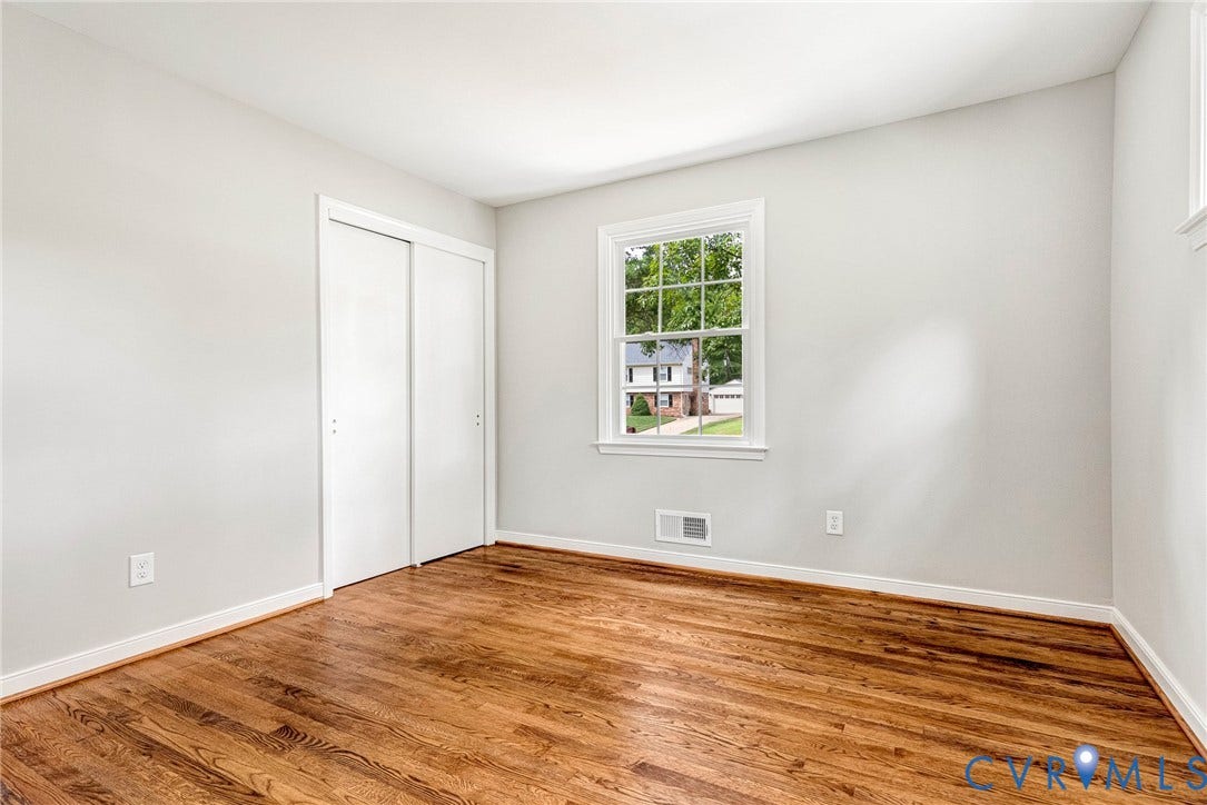 1605 CLOISTER Drive, Henrico, VA 23228 Hardwood flooring, white walls, white trim, white sliding closet doors, and a double-hung window