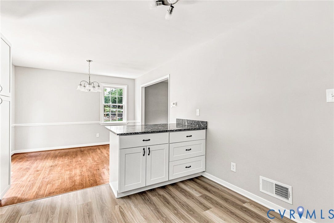 1605 CLOISTER Drive, Henrico, VA 23228 White cabinetry with dark hardware, stone countertop, wood-finish flooring, and a window with natural light