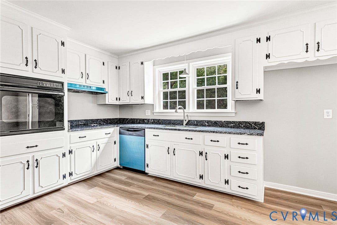 1605 CLOISTER Drive, Henrico, VA 23228 White cabinetry, dark stone-finish countertops, built-in wall oven, stainless steel sink, and wood-finish flooring