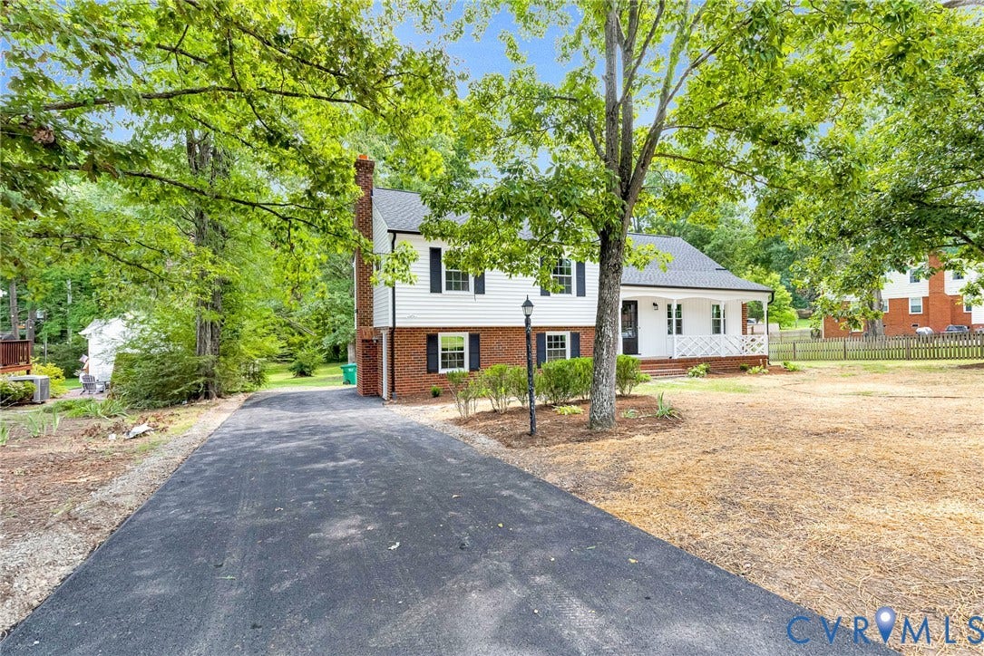 1605 CLOISTER Drive, Henrico, VA 23228 White siding exterior with brick foundation, black shutters, and a covered front porch featuring a white railing