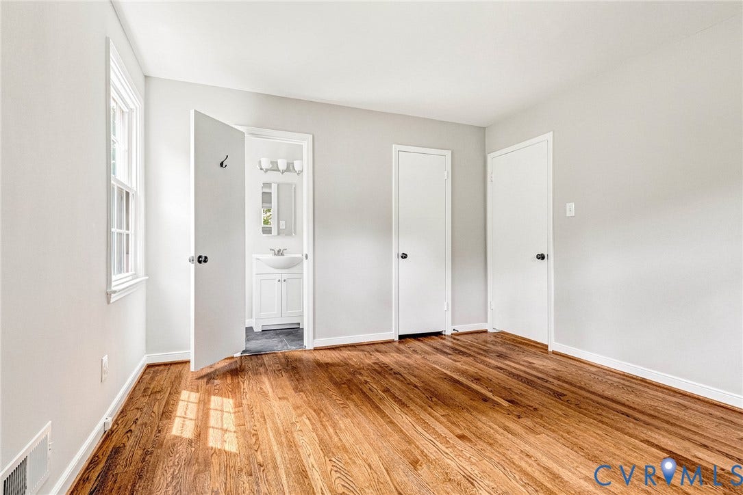 1605 CLOISTER Drive, Henrico, VA 23228 Hardwood flooring, painted walls, white trim, white paneled doors, and a double-hung window