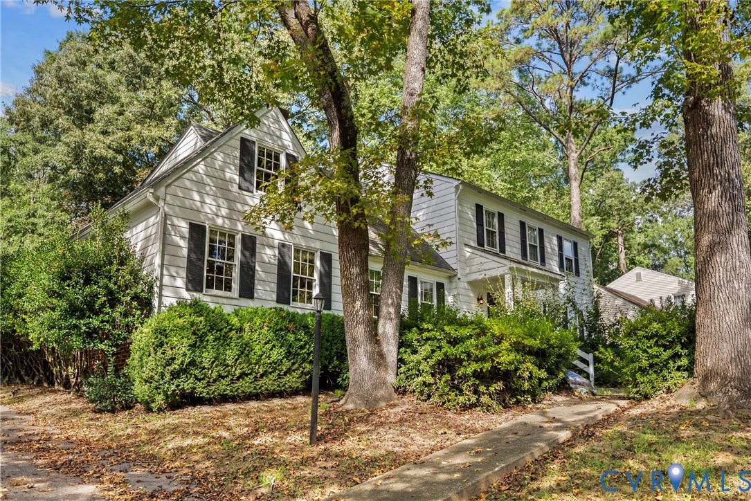 White siding exterior with black window shutters