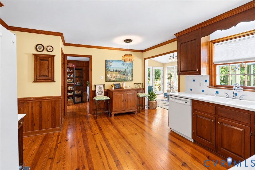 Wood-finish flooring throughout, with wood wainscoting and trim