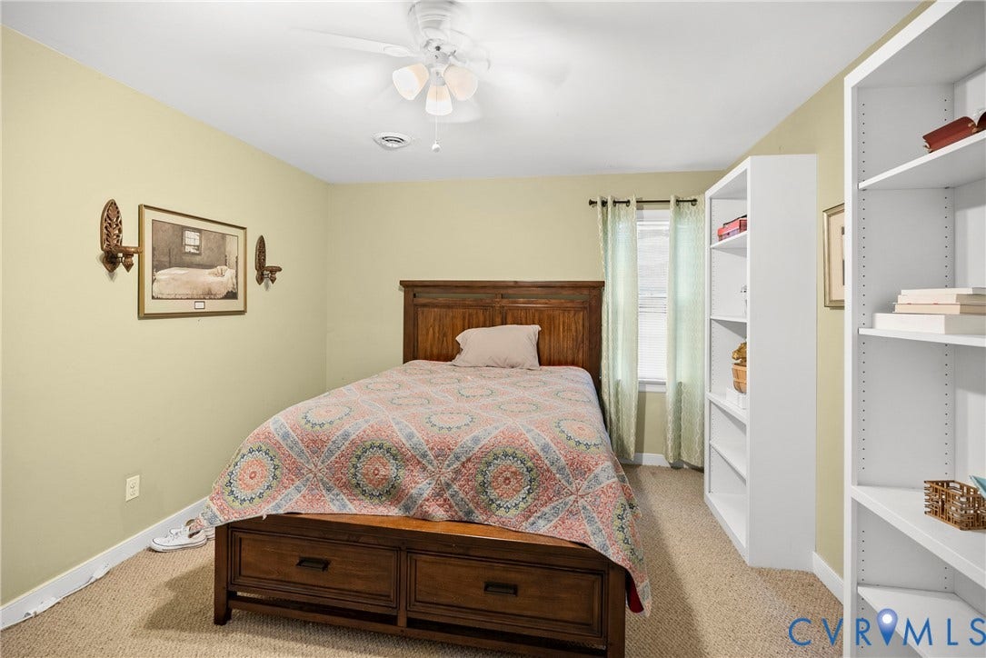 Recessed lighting, ceiling fan, window with curtains, and built-in shelving