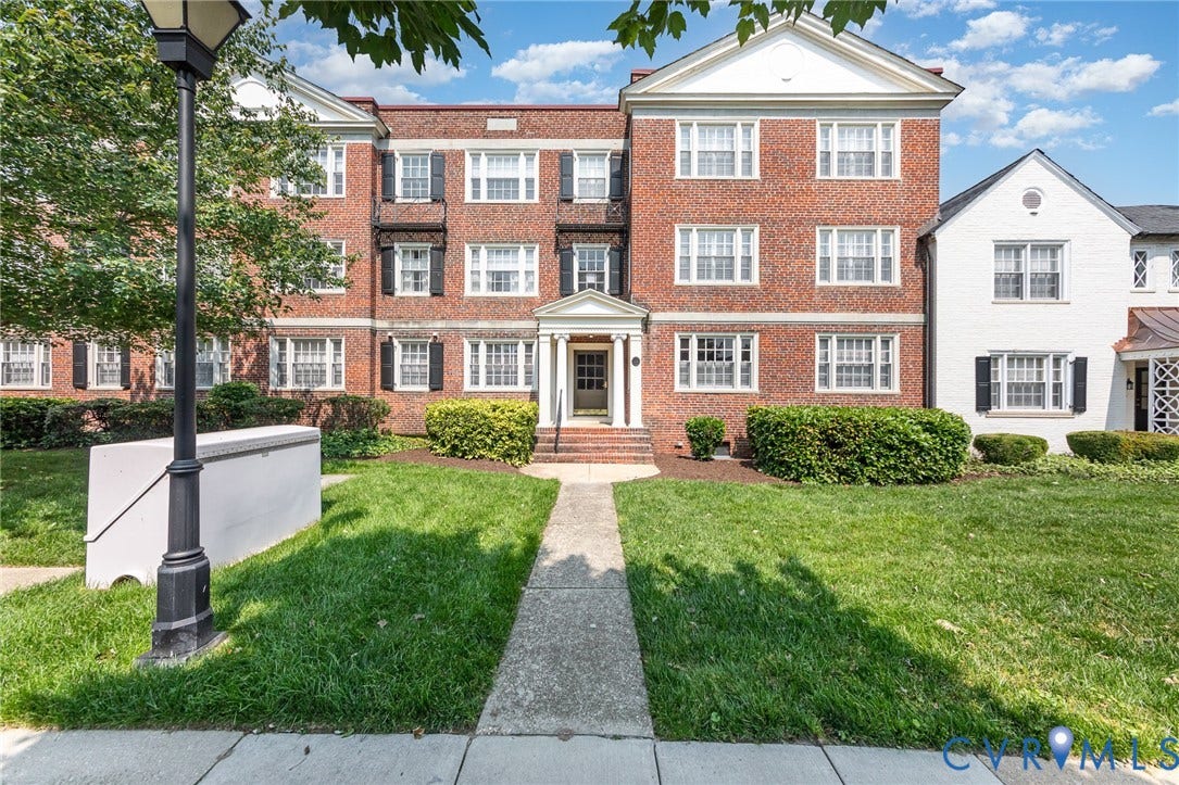 24 W Locke Lane, #1, Richmond, VA 23226 Brick facade building with white trim, black shutters, and a covered main entrance