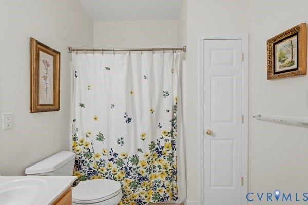 White three-panel door, white toilet, white wall-mounted towel bar