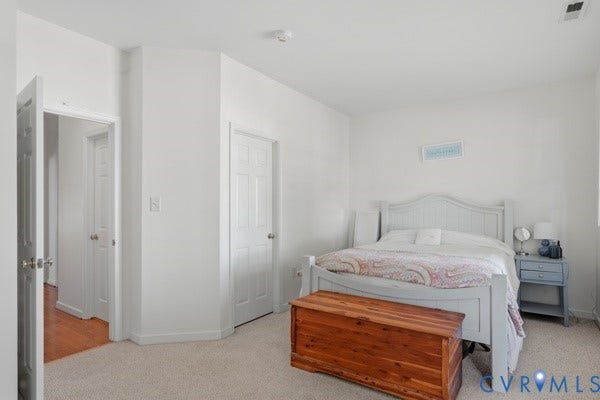 Neutral wall finishes, recessed lighting, and carpeted flooring