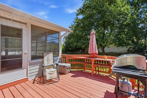 Expansive red-tone wood deck featuring a built-in bench