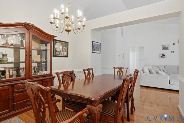 Hardwood flooring and white walls with crown molding