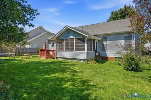 Expansive backyard featuring a screened porch, an additional wood deck, and a privacy fence