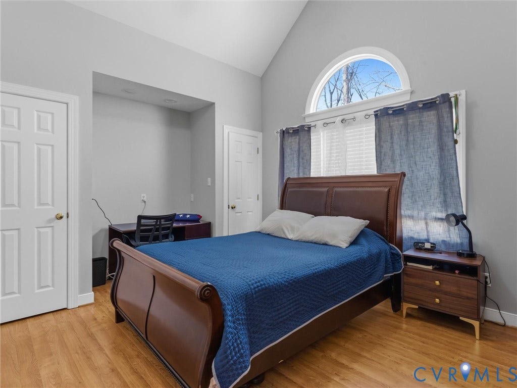 3489 Richards Run, Powhatan, VA 23139 Vaulted ceiling with an arched window, wood-finish flooring, recessed lighting, and a built-in desk alcove