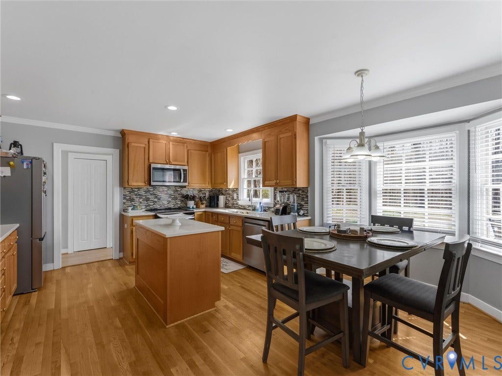 3489 Richards Run, Powhatan, VA 23139 Wood-finish flooring, recessed lighting, wood cabinetry, stainless steel appliances, and a bay window with blinds