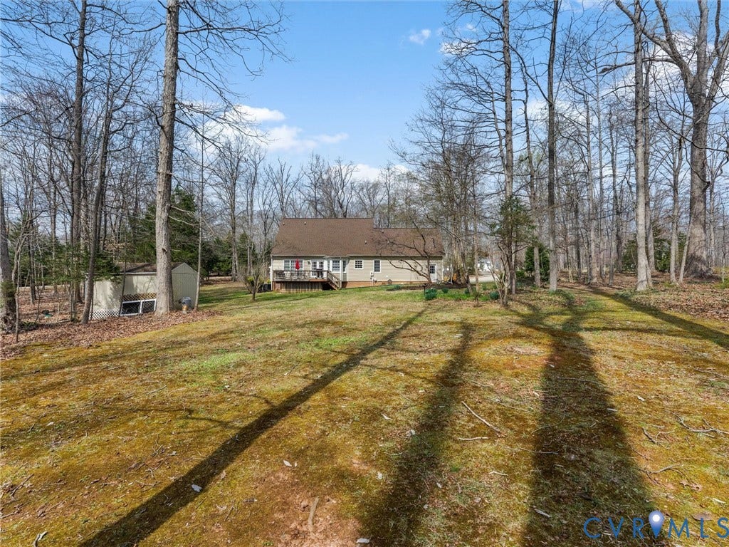 3489 Richards Run, Powhatan, VA 23139 Expansive backyard featuring a deck, mature trees, and an accessory building