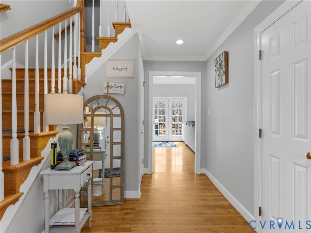 3489 Richards Run, Powhatan, VA 23139 Hardwood flooring, painted white interior doors, crown molding, a staircase with white spindles, and recessed lighting