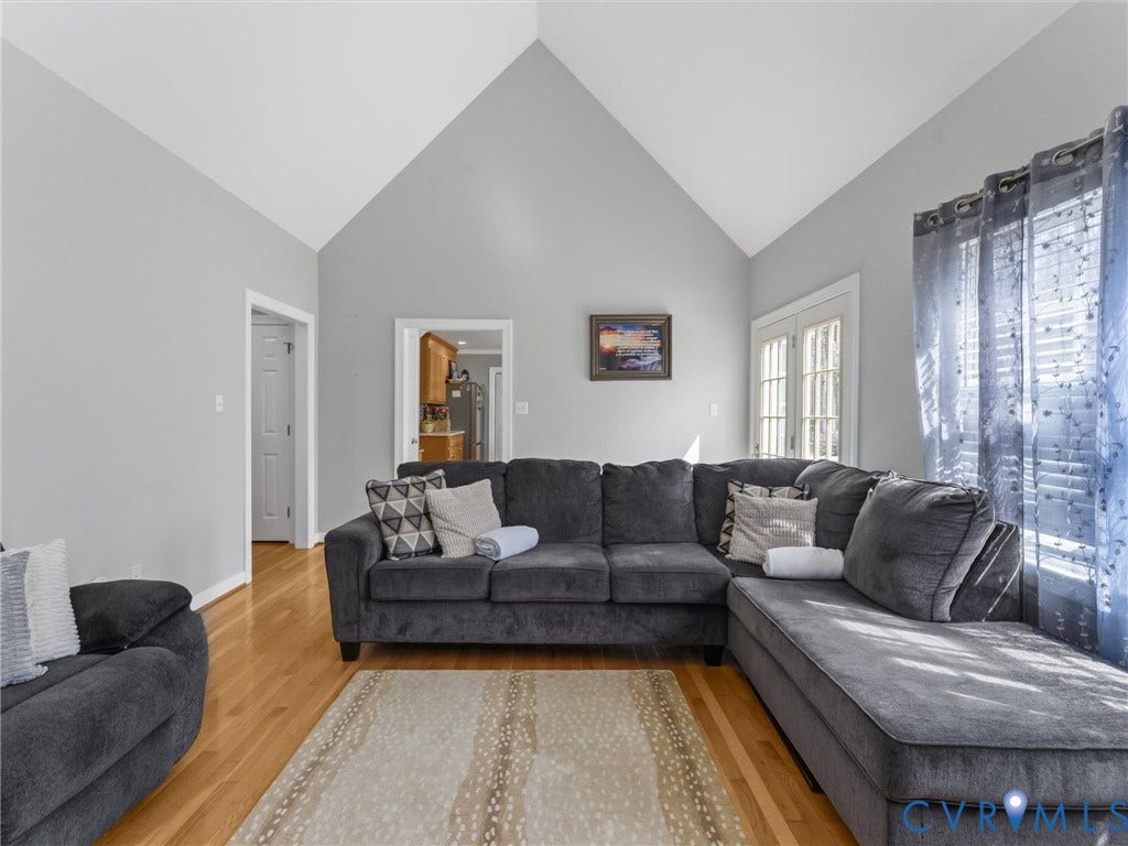 3489 Richards Run, Powhatan, VA 23139 Vaulted ceiling, wood-finish flooring, French doors, and light gray wall paint