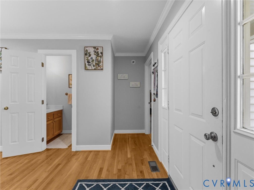 3489 Richards Run, Powhatan, VA 23139 Hardwood flooring, painted interior doors, crown molding, and a bathroom vanity with wood-finish cabinetry