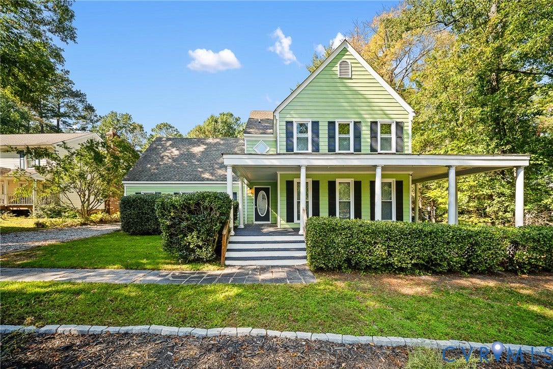 1608 Queens Point Drive, Henrico, VA 23238 Two-story exterior featuring light-toned horizontal siding, a wrap-around front porch with structural columns, multi-pane windows with dark shutters, and an asphalt shingle roof