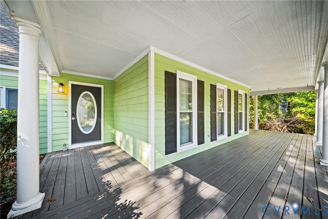 1608 Queens Point Drive, Henrico, VA 23238 Covered front porch featuring wood-plank flooring, decorative columns, lap siding, shutter-framed windows, and an oval-insert front door