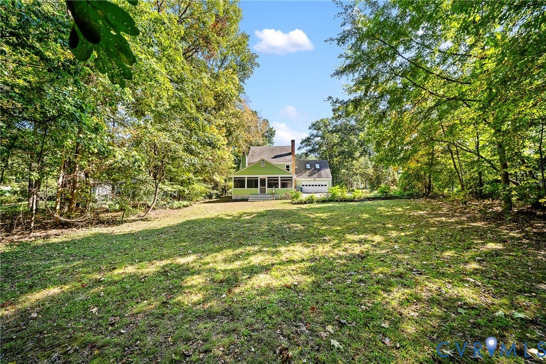 1608 Queens Point Drive, Henrico, VA 23238 Expansive lot featuring mature trees, a screened-in porch, attached garage, and a wood-sided exterior