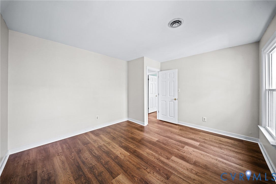 1608 Queens Point Drive, Henrico, VA 23238 Neutral-toned walls, wood-finish flooring, and a multi-panel interior door