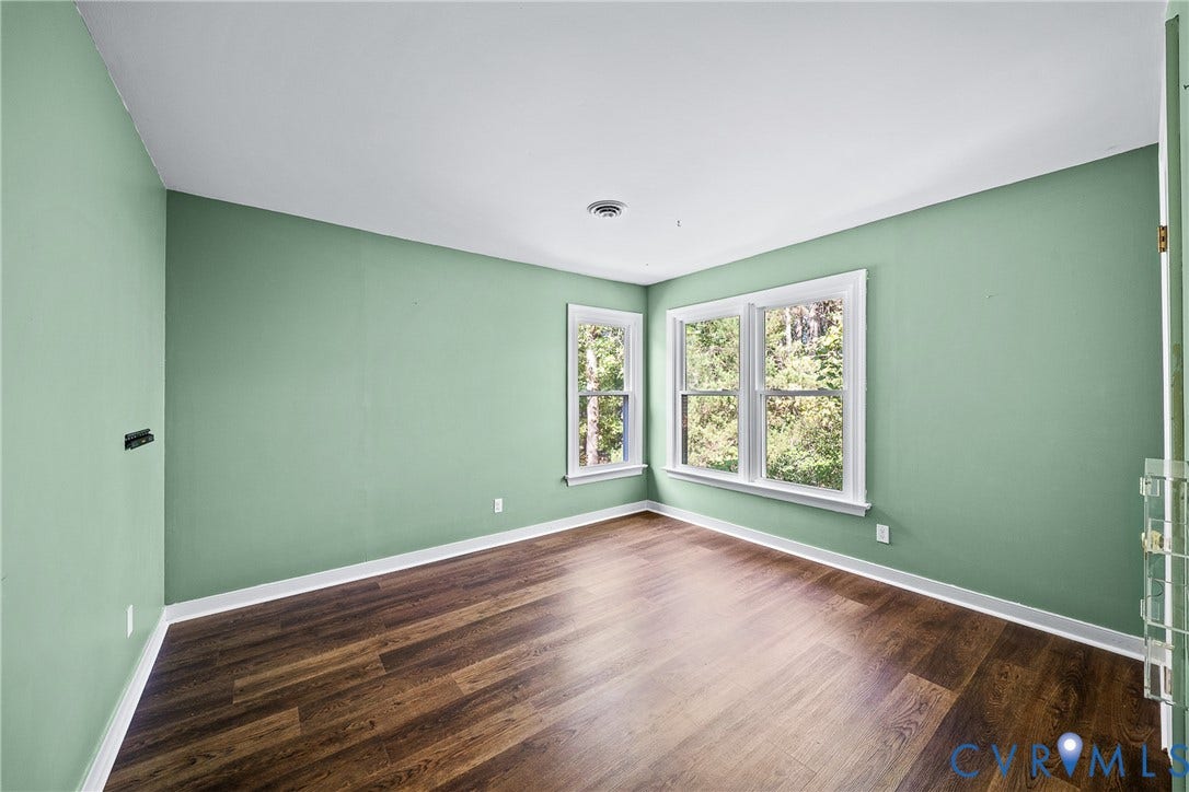 1608 Queens Point Drive, Henrico, VA 23238 Room featuring wood-finish flooring, crisp white trim, and oversized double-hung windows