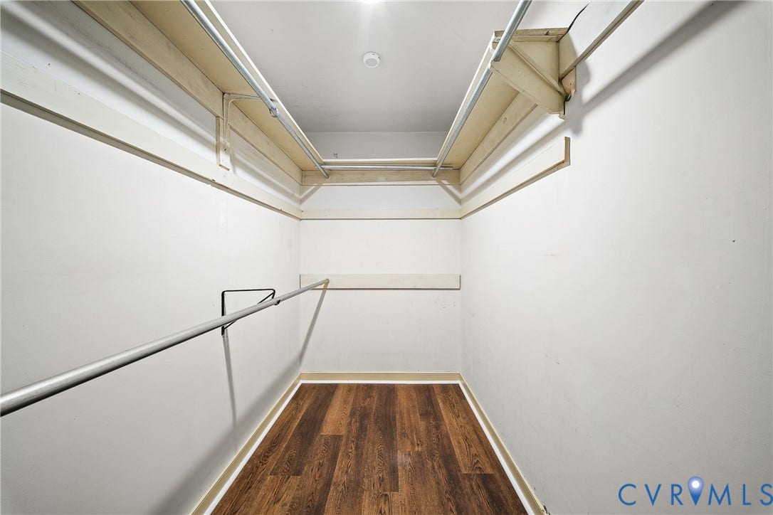 1608 Queens Point Drive, Henrico, VA 23238 Walk-in closet featuring wood-finish flooring, tiered shelving, and dual-level metal hanging rods