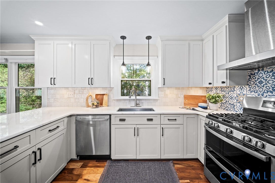 1608 Queens Point Drive, Henrico, VA 23238 Kitchen featuring white shaker-style cabinetry, stainless steel appliances, solid surface countertops, patterned tile backsplash, and wood-finish flooring