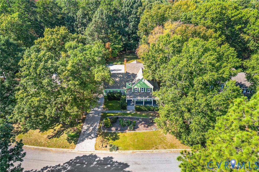 1608 Queens Point Drive, Henrico, VA 23238 Two-story home with a covered front porch, light-toned exterior siding, asphalt shingle roof, long concrete driveway, and mature landscaping on a wooded lot