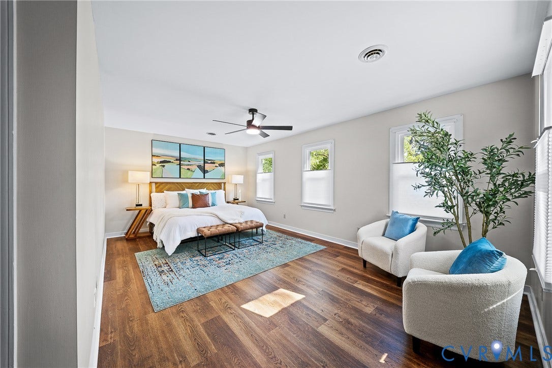 1608 Queens Point Drive, Henrico, VA 23238 Room featuring wood-finish flooring, three windows with custom cellular shades, and a ceiling-mounted fan with integrated lighting