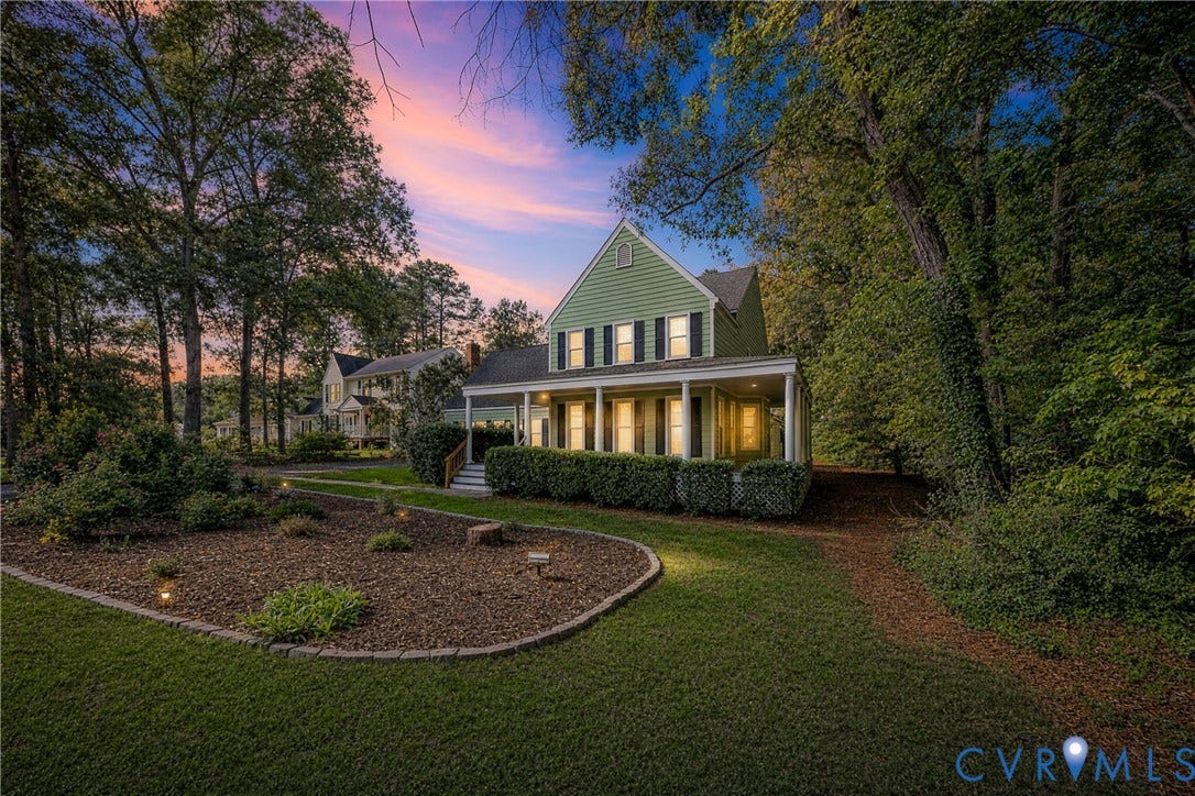 1608 Queens Point Drive, Henrico, VA 23238 Traditional exterior featuring horizontal lap siding, covered front porch with columns, multi-pane windows with shutters, and mature wooded surroundings